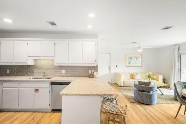 a kitchen with a stove and white cabinets