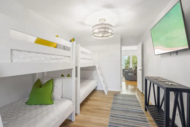 a view of a bedroom and wooden floor