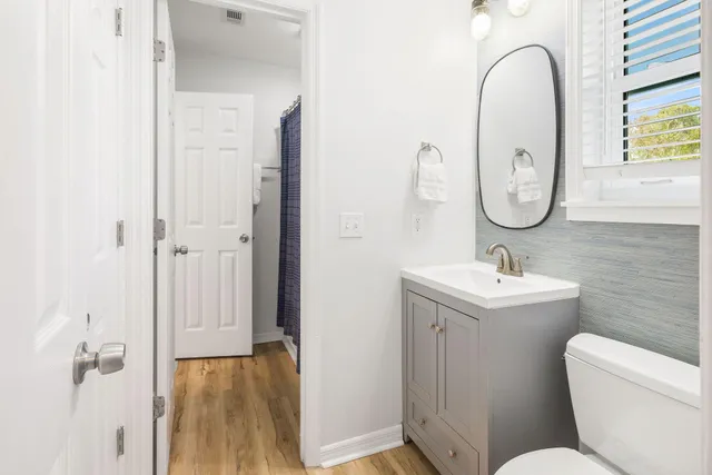 a bathroom with a toilet sink and mirror