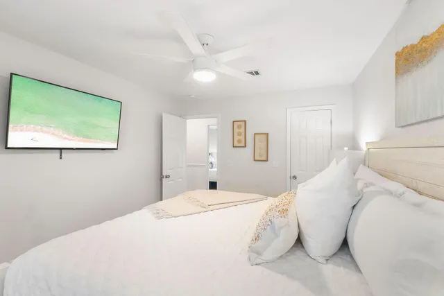 a large white bed in a white room