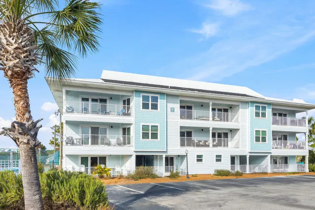 a front view of a building with a garden