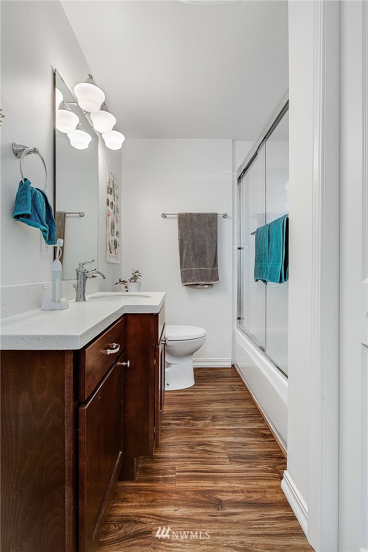 834 15th Avenue Seattle, WA 98122 - Photo 12 of 23 a spacious bathroom with a sink and a mirror