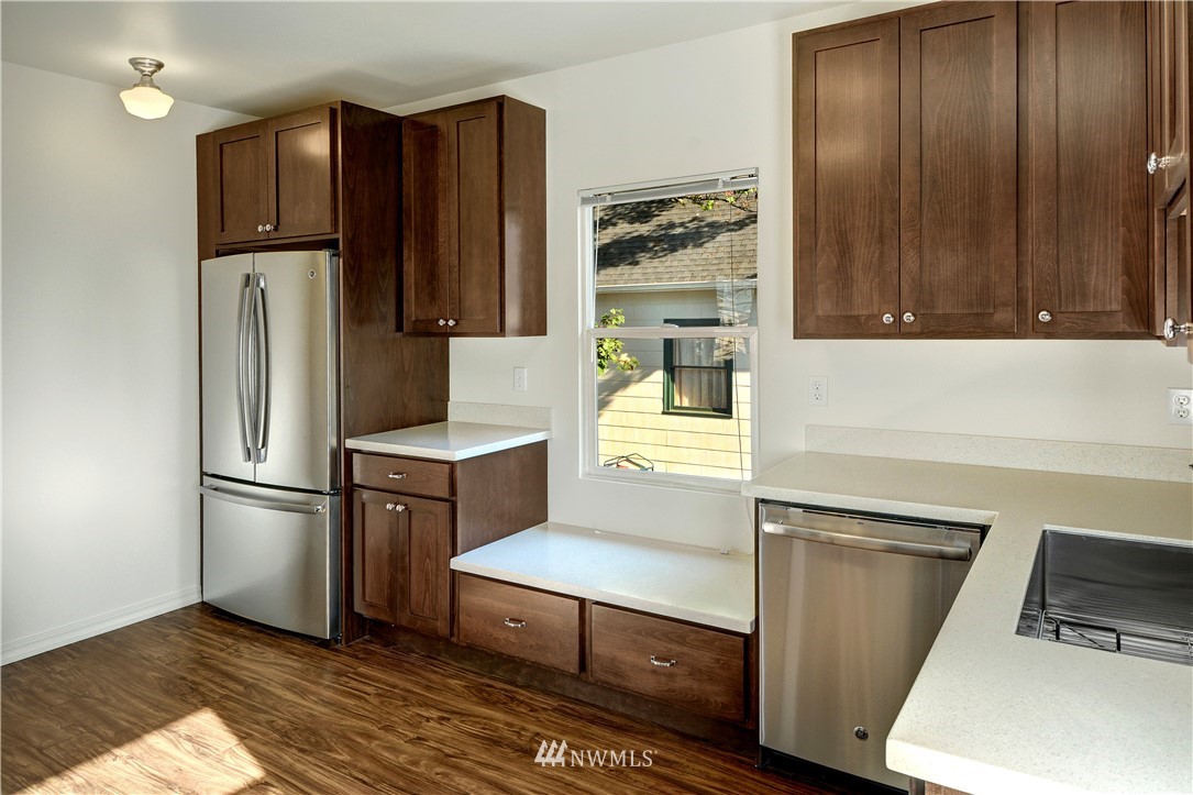 834 15th Avenue Seattle, WA 98122 - Photo 16 of 23 a kitchen with stainless steel appliances a refrigerator and a stove top oven