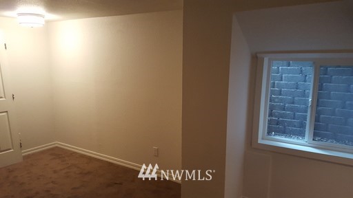 834 15th Avenue Seattle, WA 98122 - Photo 22 of 23 a view of an empty room with a window