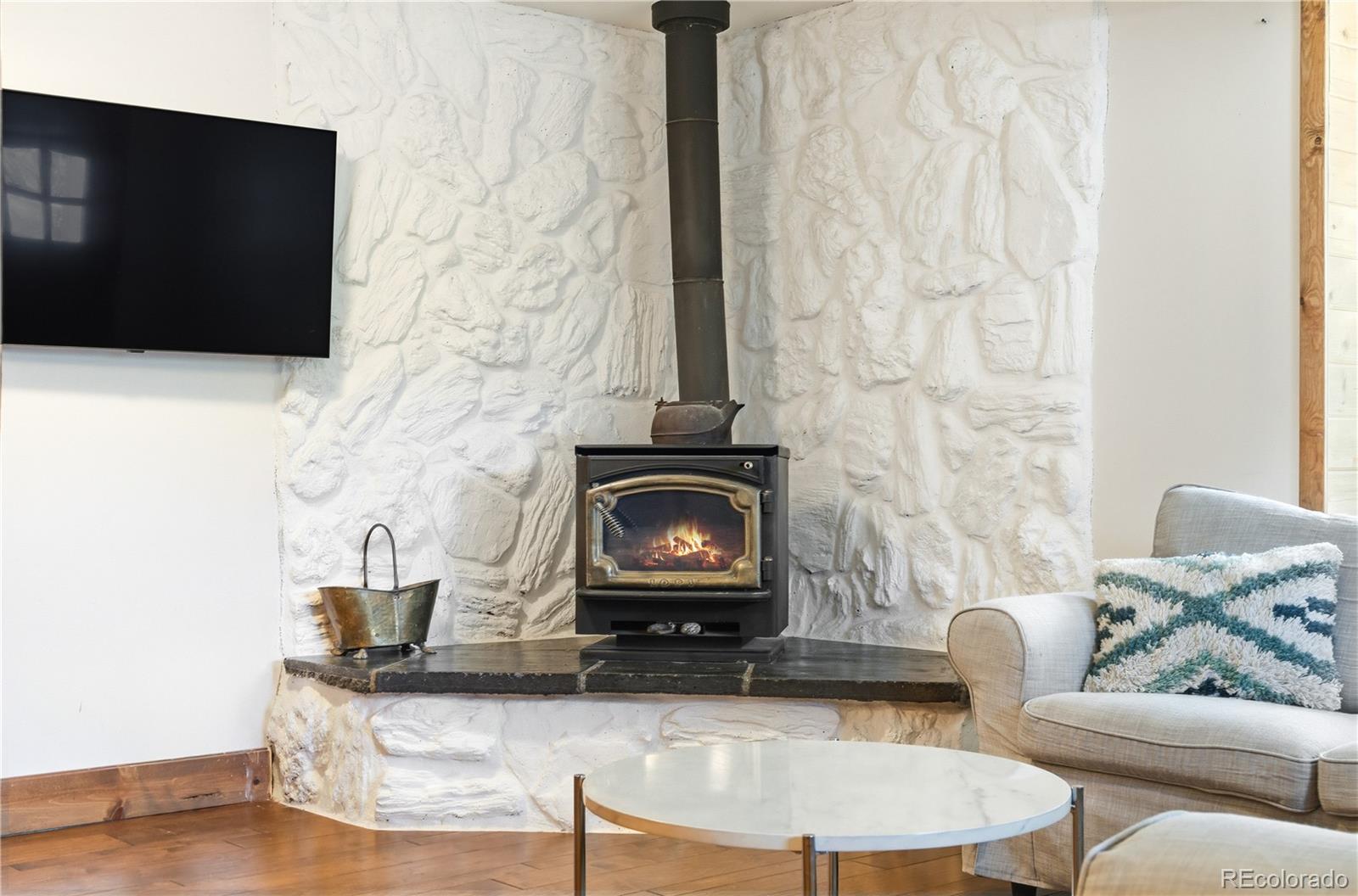 1463 Main Street Georgetown, CO 80444 - Photo 12 of 47 a living room with furniture and a fireplace