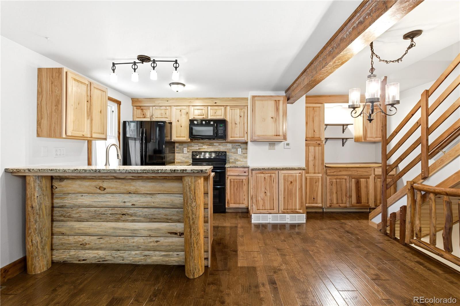 1463 Main Street Georgetown, CO 80444 - Photo 14 of 47 a view of kitchen with cabinets and wooden floor