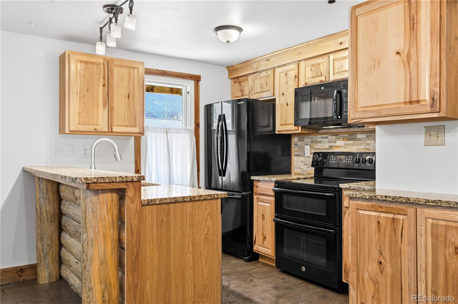1463 Main Street Georgetown, CO 80444 - Photo 17 of 47 a kitchen with stainless steel appliances granite countertop a refrigerator stove and sink