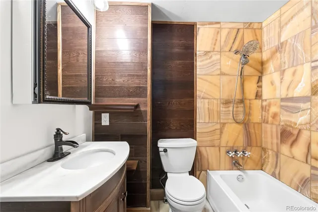 a bathroom with a sink a toilet and mirror