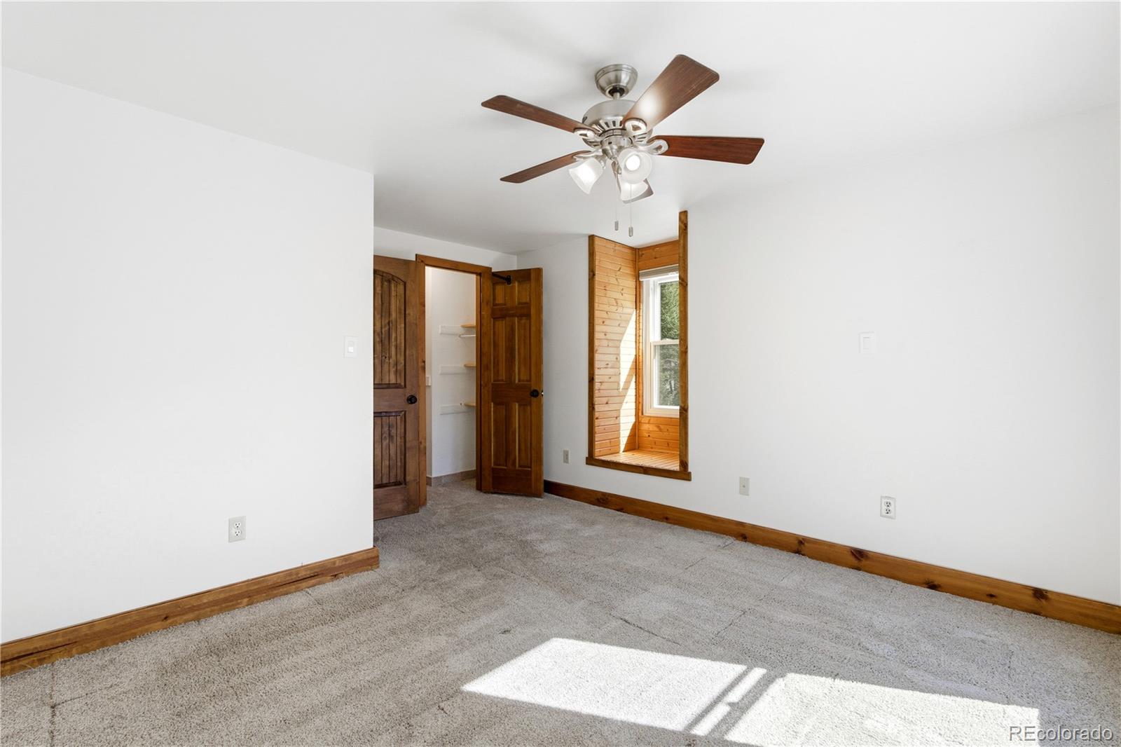 1463 Main Street Georgetown, CO 80444 - Photo 21 of 47 an empty room with windows and fan
