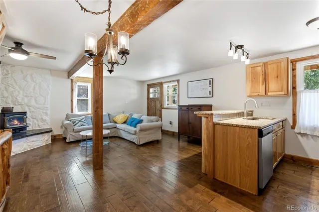 a living room with furniture and a chandelier