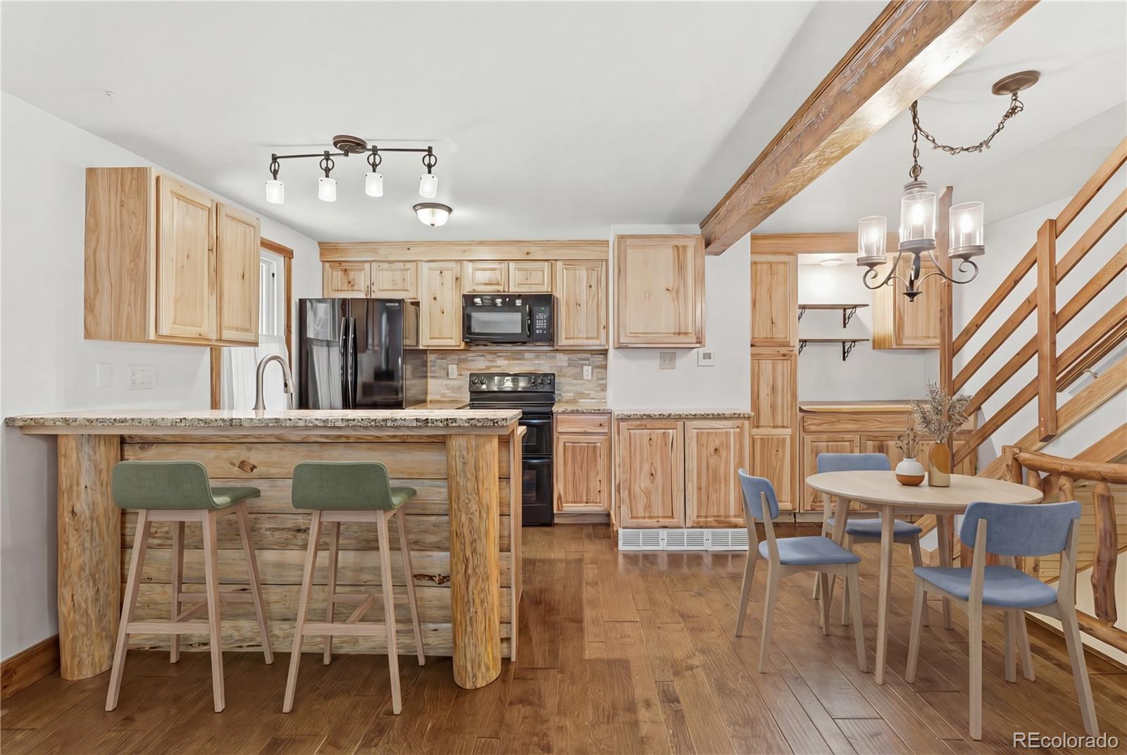 1463 Main Street Georgetown, CO 80444 - Photo 6 of 47 a kitchen with cabinets and chairs