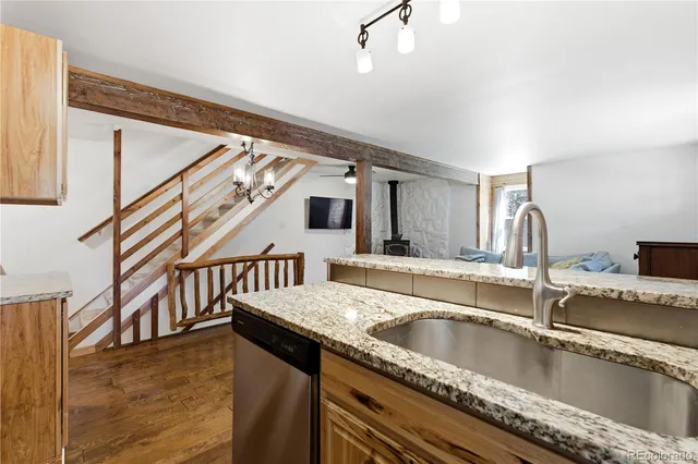 a kitchen with sink and mirror