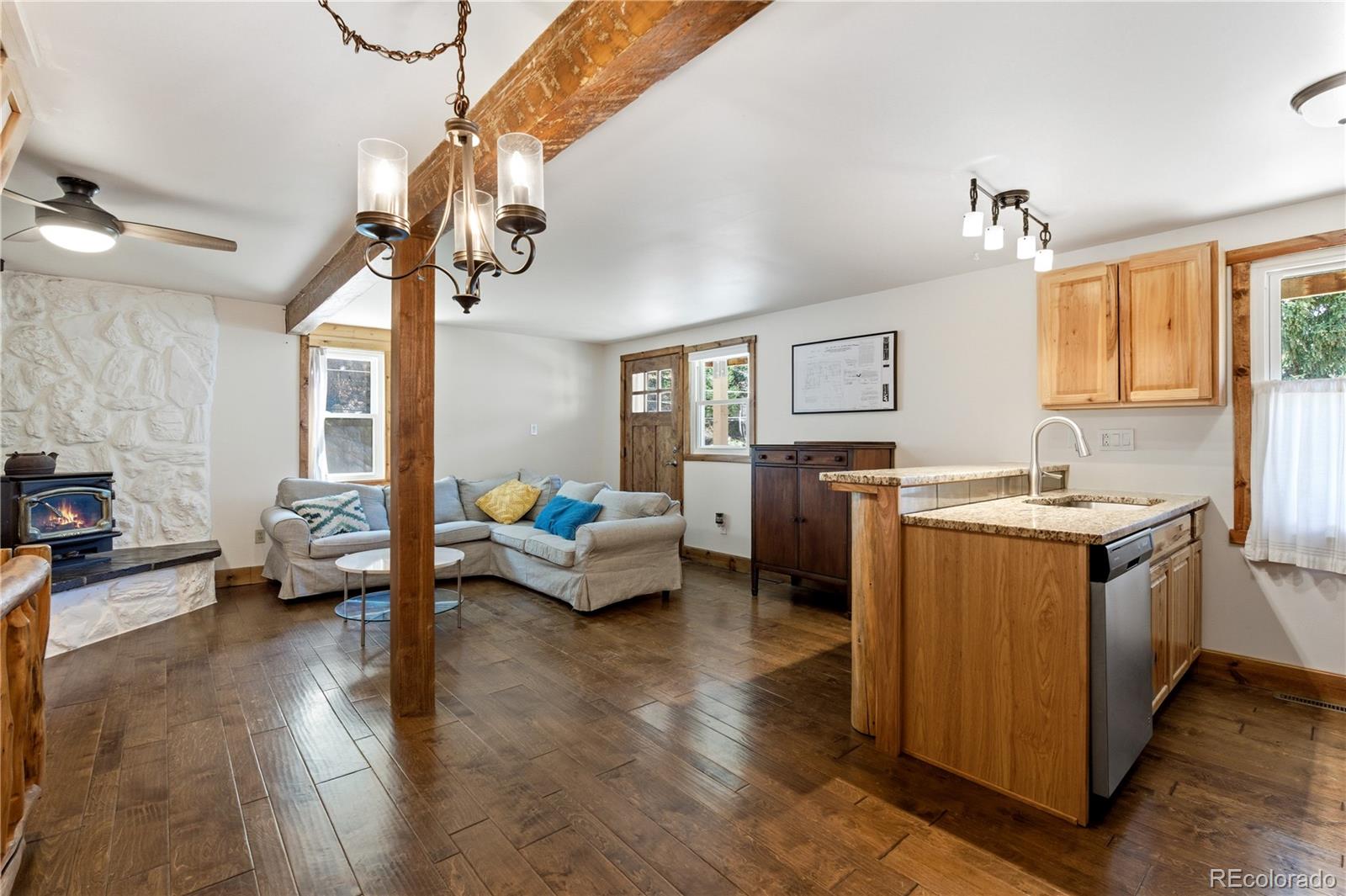 1463 Main Street Georgetown, CO 80444 - Photo 10 of 47 a living room with furniture and a chandelier