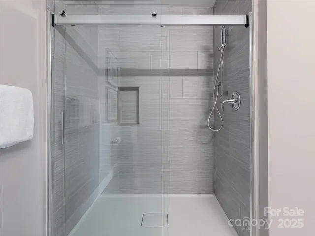 a bathroom with a glass shower door