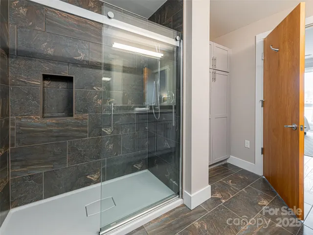 a bathroom with a glass shower door