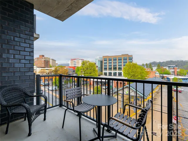 a view of a balcony with chairs