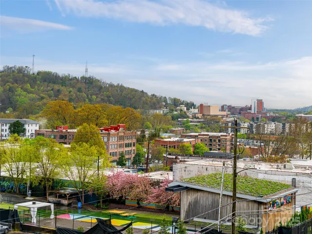 a view of a brick building next to a yard