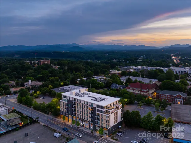 a view of a city & a lots of trees