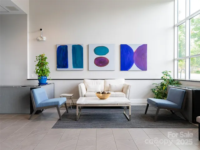 a living room with furniture and flowers