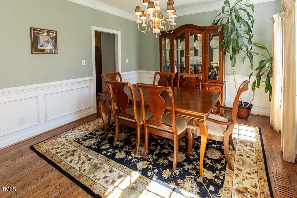 5924 North Hawthorne Way Raleigh, NC 27613 - Photo 15 of 45 a view of a dining room with furniture and chandelier