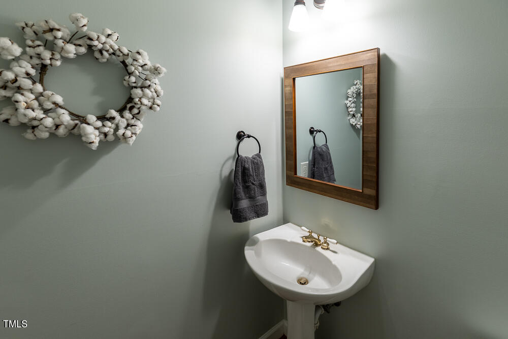 5924 North Hawthorne Way Raleigh, NC 27613 - Photo 18 of 45 a bathroom with a sink and mirror