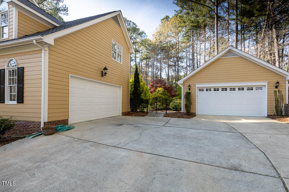 5924 North Hawthorne Way Raleigh, NC 27613 - Photo 2 of 45 a front view of a house with a yard and garage