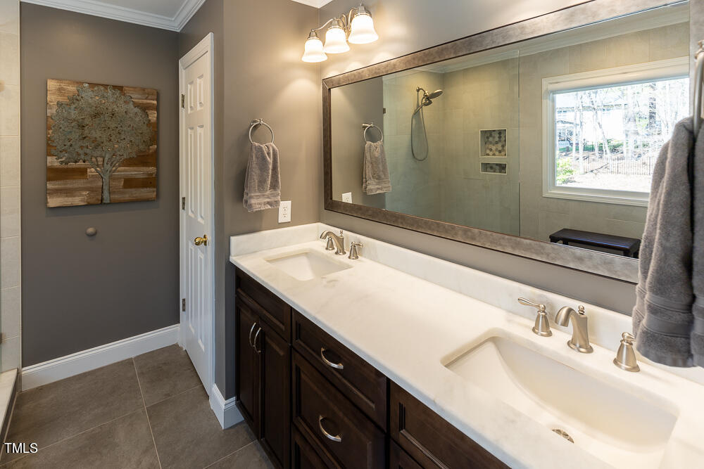 5924 North Hawthorne Way Raleigh, NC 27613 - Photo 25 of 45 a bathroom with a sink and a mirror