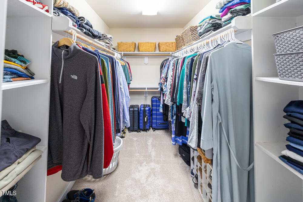 5924 North Hawthorne Way Raleigh, NC 27613 - Photo 27 of 45 a view of walk in closet with clothes and shoes