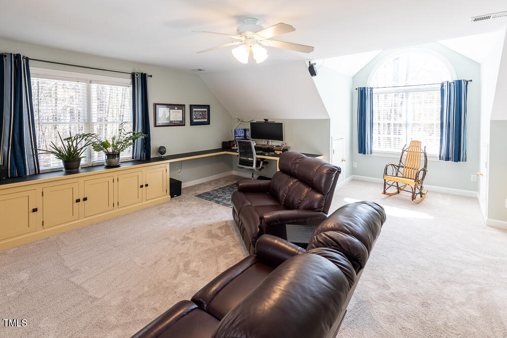5924 North Hawthorne Way Raleigh, NC 27613 - Photo 31 of 45 a living room with furniture and a flat screen tv