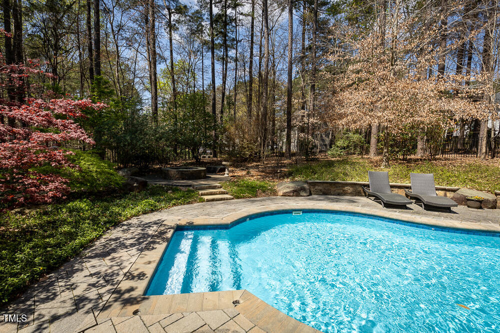 5924 North Hawthorne Way Raleigh, NC 27613 - Photo 35 of 45 a view of yard with swimming pool and trees