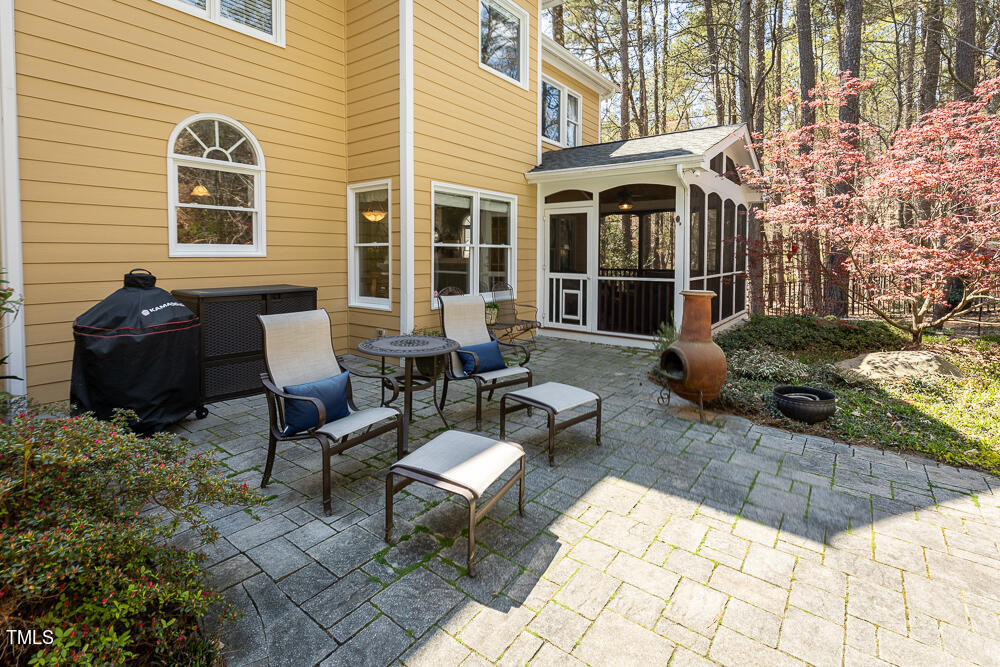 5924 North Hawthorne Way Raleigh, NC 27613 - Photo 36 of 45 a view of a patio with couches table and chairs and potted plants