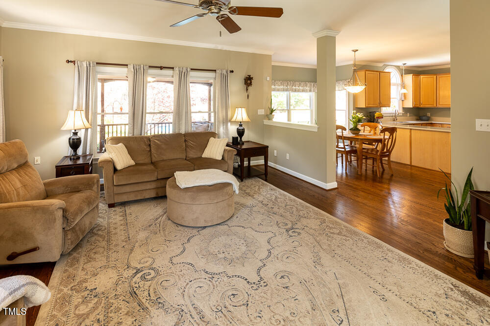 5924 North Hawthorne Way Raleigh, NC 27613 - Photo 6 of 45 a living room with furniture and a table with wooden floor