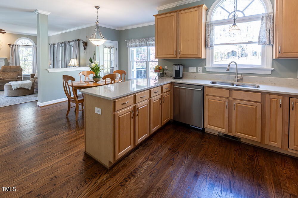 5924 North Hawthorne Way Raleigh, NC 27613 - Photo 10 of 45 a kitchen with a sink window and cabinets