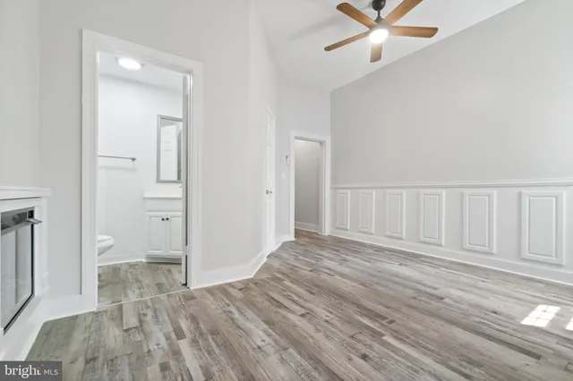 a view of entryway and hall with wooden floor