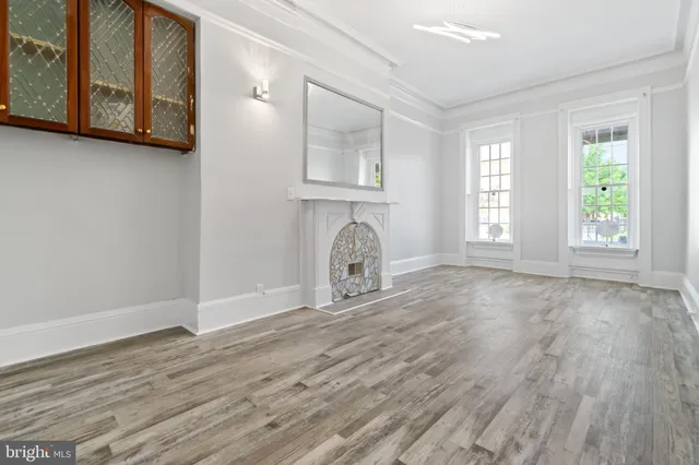 a view of a kitchen with a fridge wooden floor and a window
