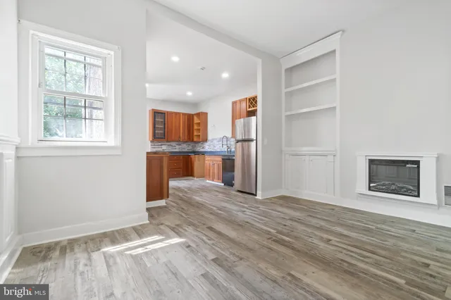 a bathroom with a granite countertop sink a mirror and a bathtub
