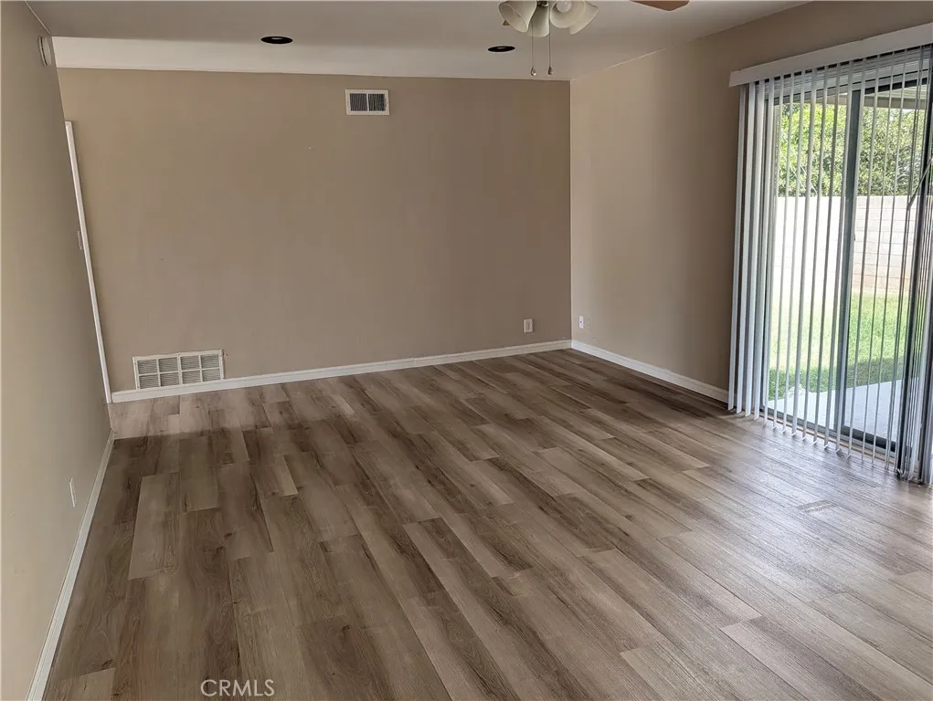 8641 Garfield Street, Unit 1 Riverside, CA 92504 - Photo 8 of 19 a view of an empty room with wooden floor and a window
