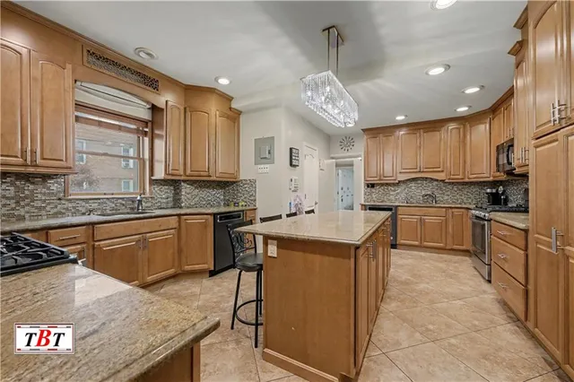 a kitchen with a stove a sink a refrigerator and cabinets