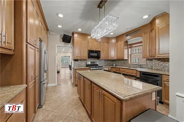 a kitchen with a sink stove and refrigerator