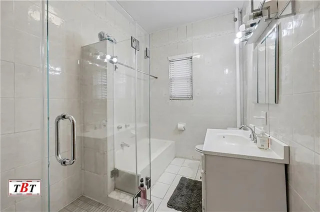 a bathroom with a shower a sink and mirror