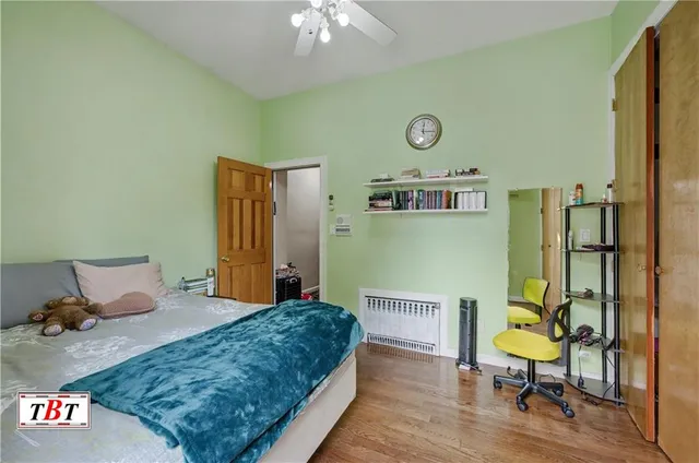 a bedroom with a bed dresser and a window