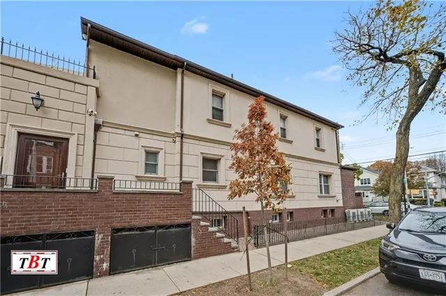 front view of a house with a tree