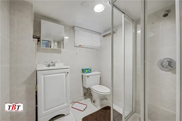 a bathroom with a toilet sink and shower