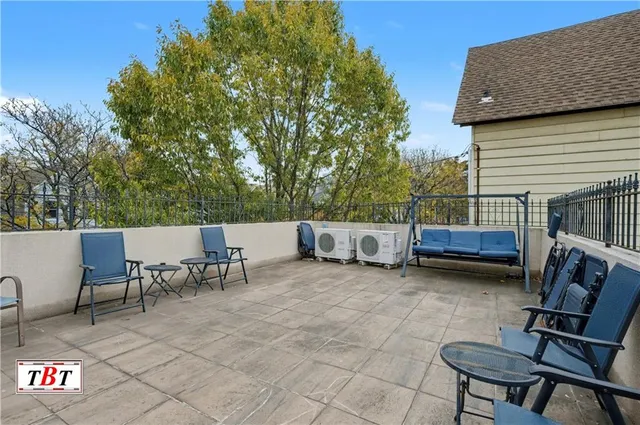 a view of a patio with a table and chairs