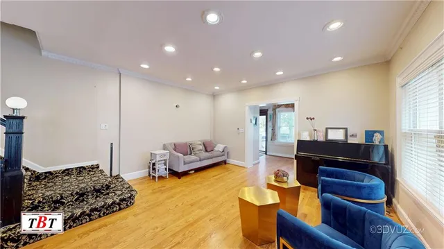 a living room with furniture and wooden floor
