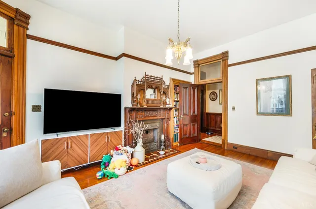 a bedroom with a bed and a flat tv screen on wall