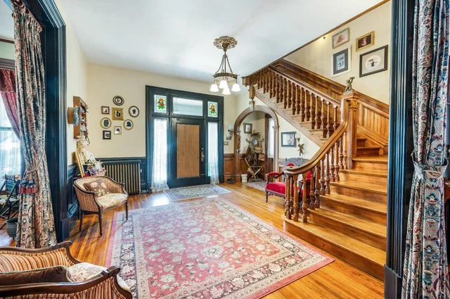 a living room with furniture a clock and a window