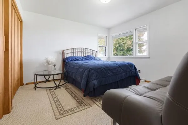 a bedroom with a bed and window
