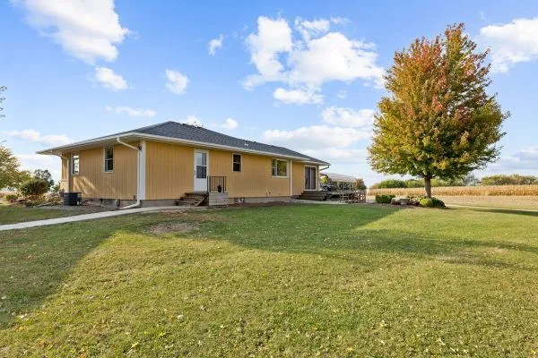 a view of back yard of the house with green space
