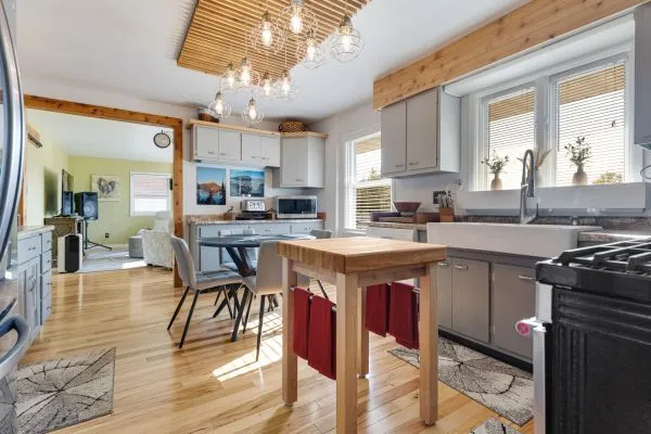 a kitchen with stainless steel appliances granite countertop a kitchen island a stove a table and chairs in it